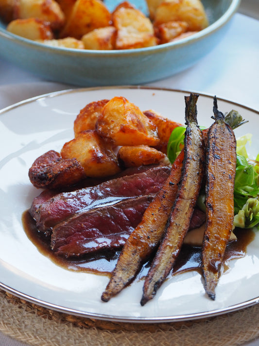 Roast venison with carrots, potatoes and gravy
